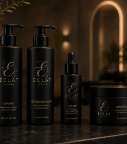 Branding salones de belleza — línea de cosmética capilar Éclat Studio con champú, acondicionador, sérum y mascarilla en envase negro mate y dorado